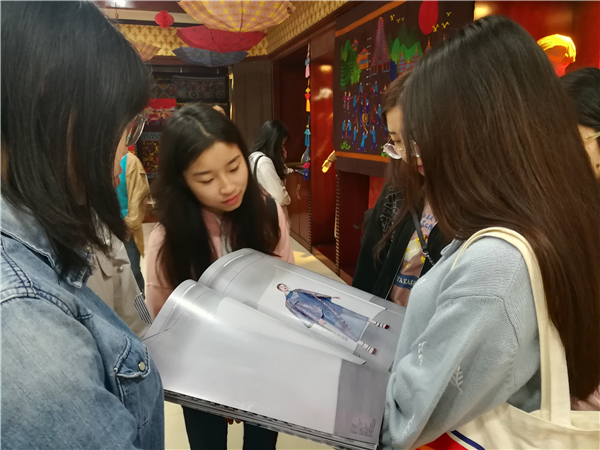 同学们欣赏工艺美术研究所研发的产品图册.jpg
